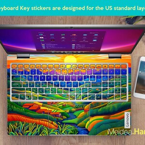 May include: A laptop keyboard with colourful landscape stickers. The stickers feature a sunset, mountains, and a river. The keyboard is labelled "Lenovo".
