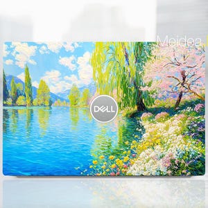 May include: A laptop skin featuring a vibrant landscape painting. The artwork depicts a serene lake reflecting a blue sky with fluffy clouds, surrounded by lush trees and colorful flowers. The Dell logo is visible.