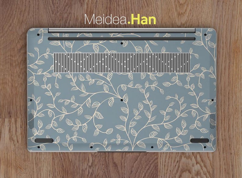 May include: A laptop skin featuring a light blue background with a repeating pattern of cream-colored vines and leaves. The skin has a rectangular shape with a vent and port cutouts. The text "Meidea.Han" is visible at the top.