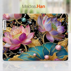 May include: A Lenovo laptop case featuring a vibrant floral design. The case showcases large, detailed lotus flowers in shades of pink and purple, accented with gold leaves and teal accents against a black background. The text "Meidea.Han" is visible.