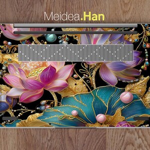 May include: Laptop skin featuring a floral design with pink, purple, and teal lotus flowers, gold leaves, and pearl accents on a black background. The text "Meidea.Han" is at the top.