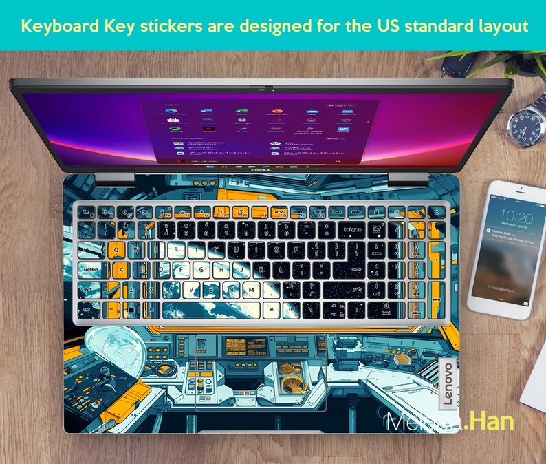 May include: A laptop computer with a keyboard sticker featuring a space-themed design. The sticker has a blue, yellow, and black color scheme and depicts a spaceship cockpit.