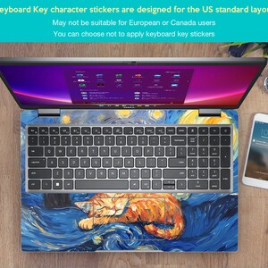 May include: A laptop computer with a keyboard sticker featuring a stylized painting of a cat sleeping on a blue and yellow background. The keyboard sticker is designed for US standard keyboards. The text "Keyboard Key character stickers are designed for the US standard layout" is visible at the top of the image. The text "May not be suitable for European or Canada users" is visible below the first line of text. The text "You can choose not to apply keyboard key stickers" is visible below the second line of text.