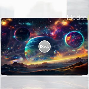 May include: A laptop skin with a colorful galaxy design featuring planets, stars, and nebulae. The Dell logo is visible in the center of the image.