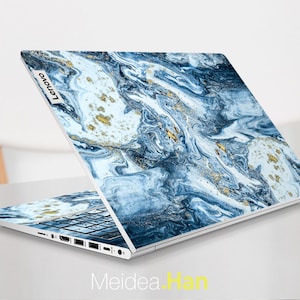 May include: A laptop computer with a blue and gold marbled design on the lid. The Lenovo logo is visible on the lid.