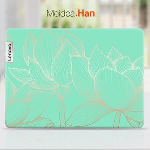May include: A green laptop skin with a white outline of lotus flowers. The skin has the word "Lenovo" printed on the left side.