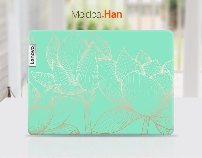 May include: A green laptop skin with a white outline of lotus flowers. The skin has the word "Lenovo" printed on the left side.