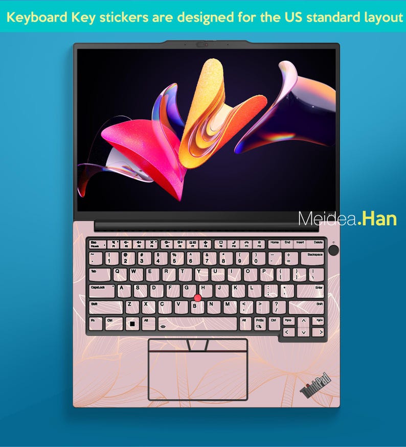 May include: A pink laptop with a floral design on the keyboard and palm rest. The screen displays a colorful abstract image. The keyboard has key stickers. Text on the screen says "Keyboard Key stickers are designed for the US standard layout".