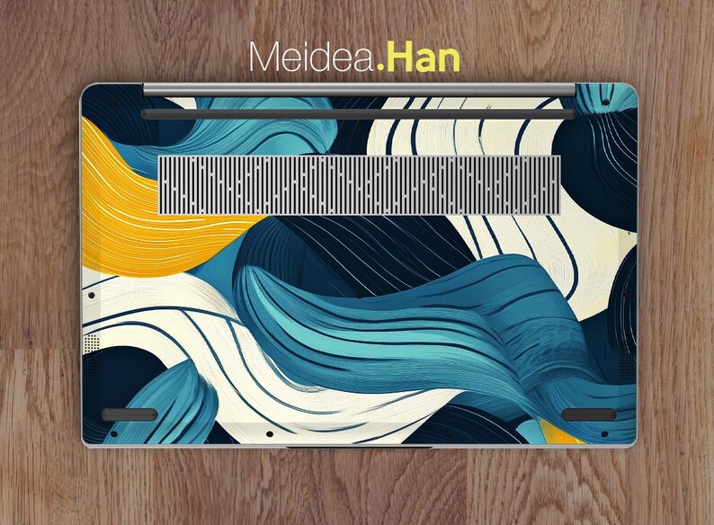 May include: A laptop with a blue, white, and yellow abstract design on the back. The design features swirling lines and shapes.