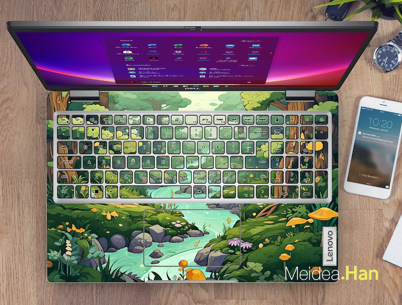 May include: A green and blue laptop skin with a cartoon forest scene and a river. The skin has a white keyboard overlay with green and blue keys. The laptop skin has the text "Lenovo" and "Meidea.Han" on it.