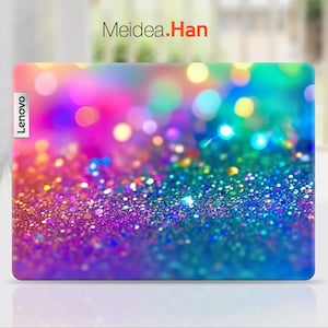 May include: A colorful laptop skin with a glittery, iridescent design. The skin features a close-up of a rainbow-colored glitter texture with a blurred background of colorful lights. The skin has the word "Lenovo" printed on the left side.