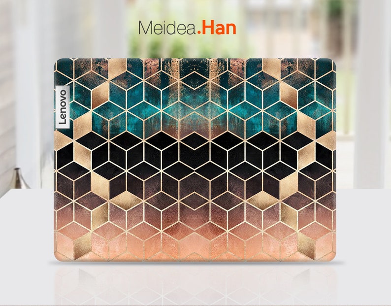 May include: A laptop skin with a geometric pattern of black, gold, and teal cubes. The skin has a gradient effect, fading from teal to gold to pink. The Lenovo logo is visible on the left side of the skin.