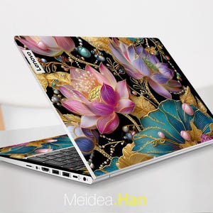 May include: A Lenovo laptop with a floral design. The laptop features a black background with gold, teal, pink, and purple flowers. The laptop is open, displaying the keyboard and screen. The text "Meidea Han" is at the bottom of the image.