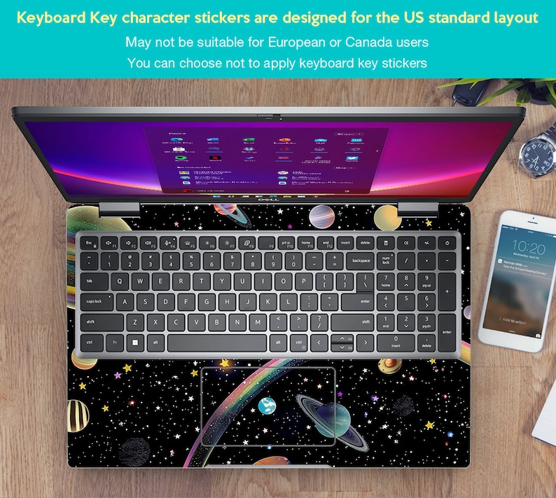 May include: A laptop computer with a black and white space-themed keyboard sticker. The sticker features planets, stars, and a rainbow. The text on the sticker reads "Keyboard Key character stickers are designed for the US standard layout. May not be suitable for European or Canada users. You can choose not to apply keyboard key stickers."