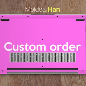 May include: The bottom of a pink laptop with the text "Custom order" printed in white on the back.