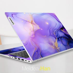 May include: A purple and gold laptop skin with a marbled design. The skin has a subtle shimmer and is perfect for adding a touch of elegance to your laptop.