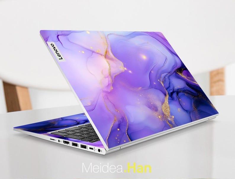 May include: A purple and gold laptop skin with a marbled design. The skin has a subtle shimmer and is perfect for adding a touch of elegance to your laptop.