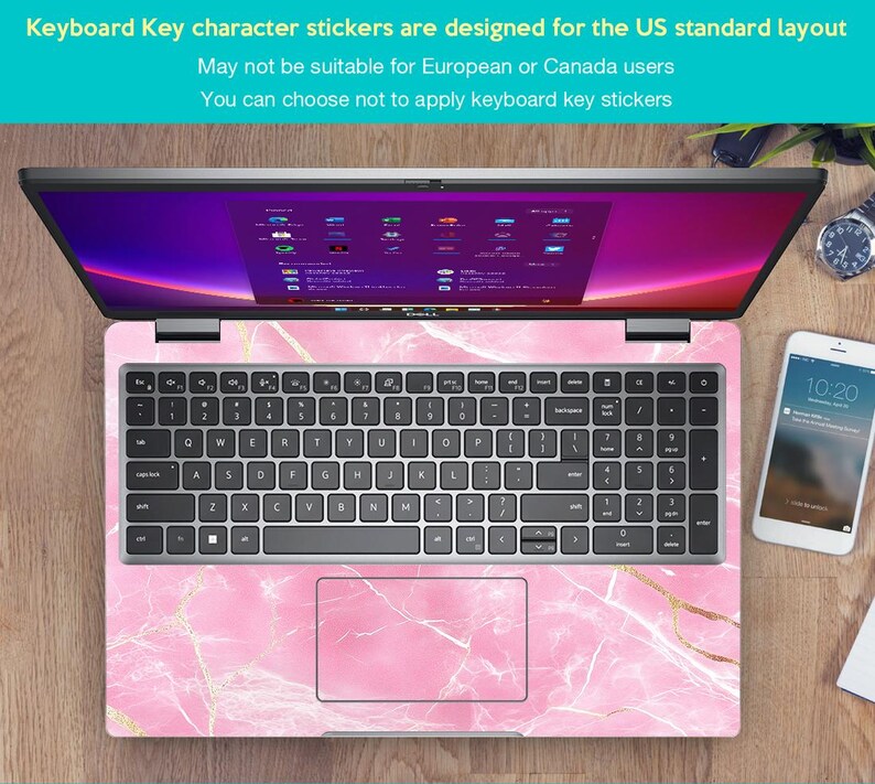 May include: A laptop computer with a pink marble design keyboard sticker. The sticker features a pink and white marble pattern with gold accents. The laptop screen is displaying a desktop with multiple icons.
