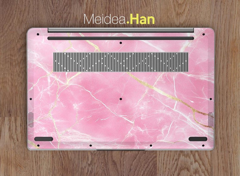 May include: Pink marble laptop skin with gold accents. The skin has a Meidea.Han logo on the top.