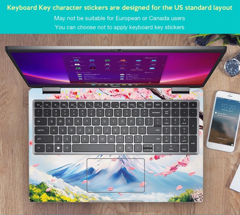 May include: A laptop computer with a keyboard and a touchpad. The laptop has a sticker on the keyboard and touchpad that features a mountain scene with pink cherry blossoms. The text on the screen reads "Windows 11 Home".