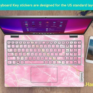 May include: Pink marble keyboard stickers designed for a US standard layout laptop keyboard. The stickers feature a pink marble pattern with gold accents. The stickers are labeled with the letters and numbers of a standard keyboard.