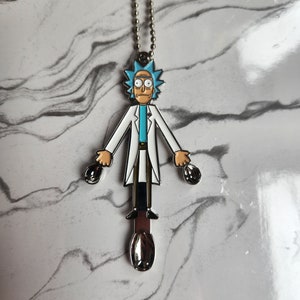 May include: A silver chain necklace with a metal charm of Rick Sanchez from the animated series Rick and Morty. The charm is a cartoon depiction of Rick in his lab coat, holding two spoons in his hands.