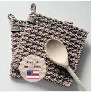 May include: Two brown crocheted pot holders with leather tags that say "Handmade". A wooden spoon is resting on top of the pot holders. The text "Crochet Instructions" is in a circle with an American flag.