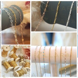 May include: Close-up of spools of gold chain, with various chain styles and sizes. The chains are arranged on a white surface.