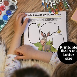 May include: A child's hands are on a coloring page titled "What Would My Donkey Say." The page features a cartoon donkey and speech bubbles. A watercolor paint set and paintbrushes are visible.