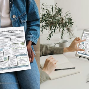 May include: A white paper titled "Processing Emotions" is held by a person wearing a denim jacket. The paper has text and diagrams in black and light blue. A tablet displays the same document. A notebook, pen, and glasses are on a white surface.