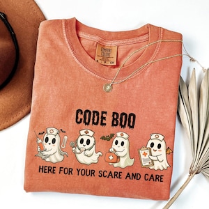 nurse Halloween Comfort Colors shirt that has 4 spooky nurses reading Code Boo: here for your scare and care for er nurse or nightshift nurse in the color yam