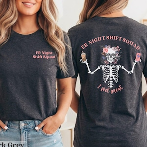 May include: Dark grey heather t-shirt with "ER Night Shift Squad" printed in pink on the front. The back features a skeleton with a floral crown, holding a coffee and a drink, with the text "I feel great".