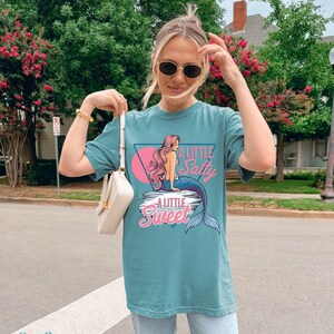 salty mermaid shirt with a retro summer vibe of mermaid that says A Little Salty A Little Sweet on a Comfort Colors shirt in the color blossom seafoam
