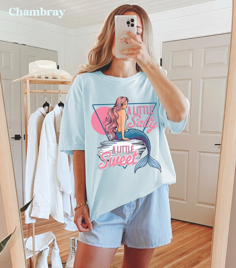 salty mermaid shirt with a retro summer vibe of mermaid that says A Little Salty A Little Sweet on a Comfort Colors shirt in the color blossom chambray light blue