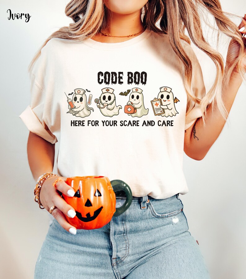nurse Halloween Comfort Colors shirt that has 4 spooky nurses reading Code Boo: here for your scare and care for er nurse or nightshift nurse in the color ivory