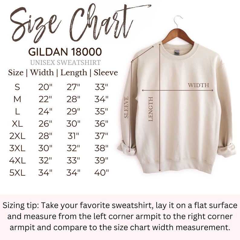 May include: A beige Gildan 18000 unisex sweatshirt displayed on a wooden hanger with an accompanying size chart. The chart lists measurements in inches for sizes S through 5XL, detailing width, length, and sleeve dimensions for the garment.