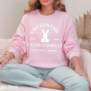 bunny sweatshirt for Easter that has a pastel bunny that says Cottontail Candy Company on a spring sweatshirt in the color light pink