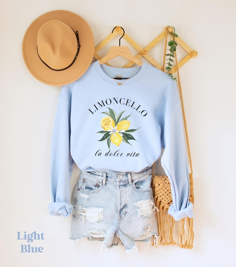 Limoncello Italian summer sweatshirt that has a summer aesthetic of fresh lemons saying Limoncello la dolce vita on a summer crewneck. Perfect gift for Italy vacation to the Amalfi Coast or Positano