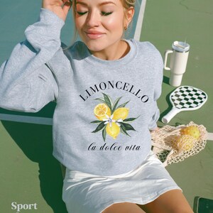 May include: A gray sweatshirt with a lemon graphic and the text "Limoncello la dolce vita".