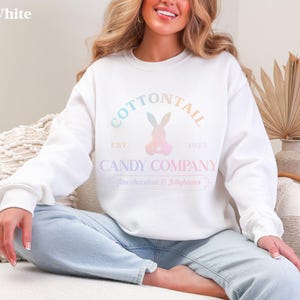 bunny sweatshirt for Easter that has a pastel bunny that says Cottontail Candy Company on a spring sweatshirt in the color white