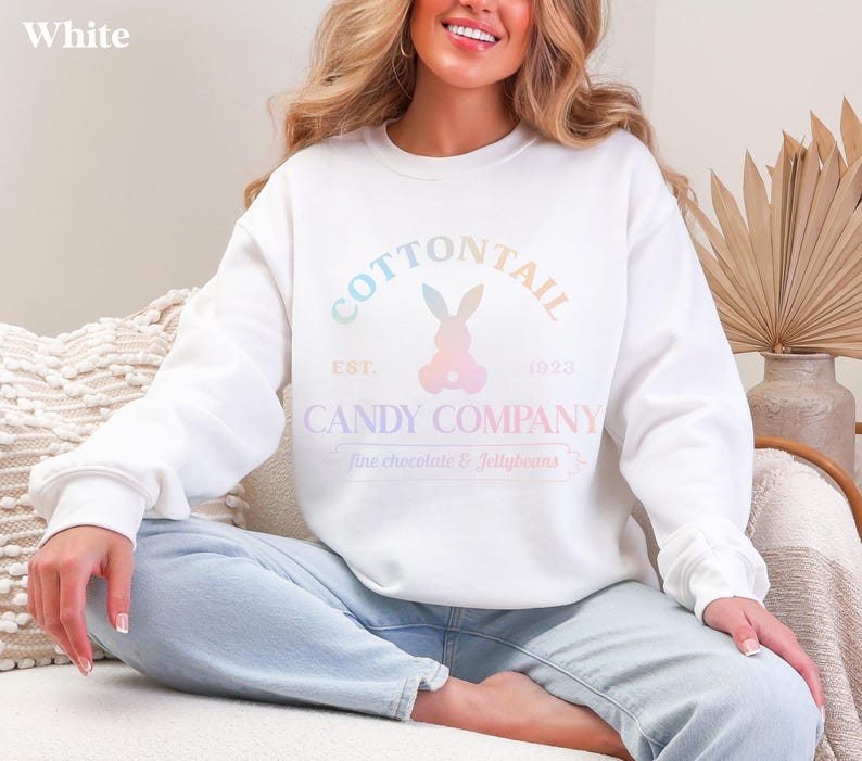 bunny sweatshirt for Easter that has a pastel bunny that says Cottontail Candy Company on a spring sweatshirt in the color white