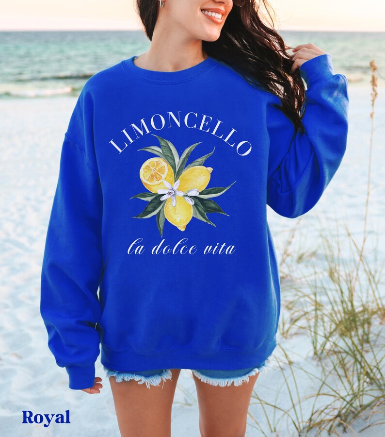 May include: A royal blue sweatshirt with the text "Limoncello la dolce vita" and a graphic of lemons and leaves.