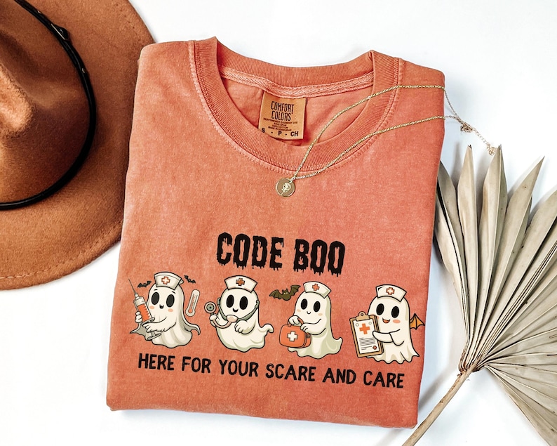 nurse Halloween Comfort Colors shirt that has 4 spooky nurses reading Code Boo: here for your scare and care for er nurse or nightshift nurse in the color yam