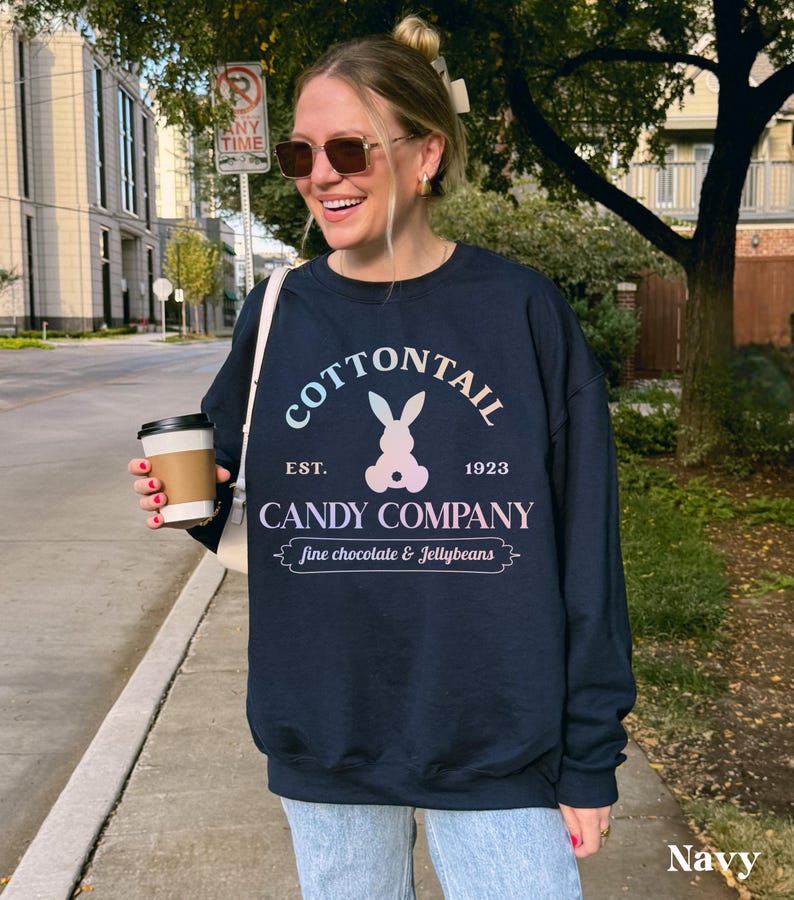 bunny sweatshirt for Easter that has a pastel bunny that says Cottontail Candy Company on a spring sweatshirt in the color navy blue