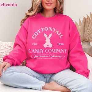 bunny sweatshirt for Easter that has a pastel bunny that says Cottontail Candy Company on a spring sweatshirt in the color heliconia pink