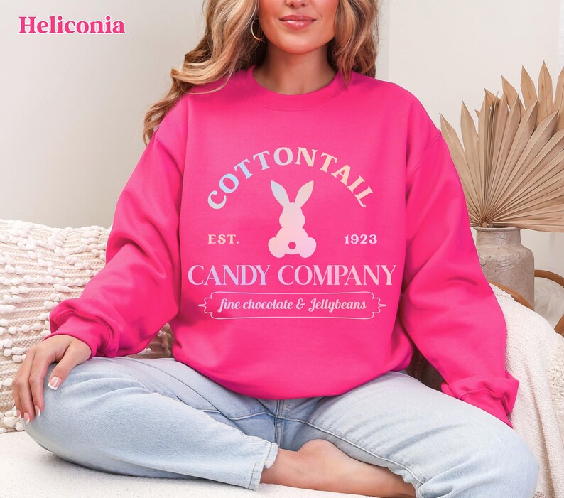bunny sweatshirt for Easter that has a pastel bunny that says Cottontail Candy Company on a spring sweatshirt in the color heliconia pink