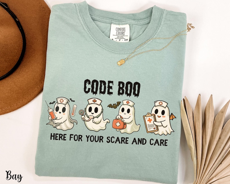 nurse Halloween Comfort Colors shirt that has 4 spooky nurses reading Code Boo: here for your scare and care for er nurse or nightshift nurse in the color bay green