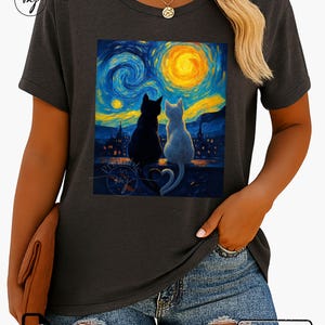 May include: Dark grey t-shirt with a painting of two cats, one black and one white, looking at a starry night sky with a yellow moon. The shirt has the text "Instant Download".