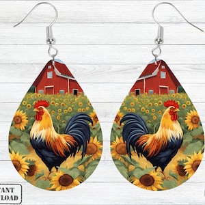 May include: A pair of teardrop-shaped earrings featuring a rooster standing in a field of sunflowers. The rooster is red, yellow, and black, and the sunflowers are yellow with green leaves. The earrings are silver and have a teardrop shape. The background is a red barn with a green roof.