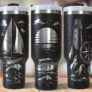 May include: Black travel mugs with white lids and handles, featuring nautical designs. One mug has a sailboat, another a sunset over water, and the third a lighthouse and compass. The mugs are approximately 9 inches tall.